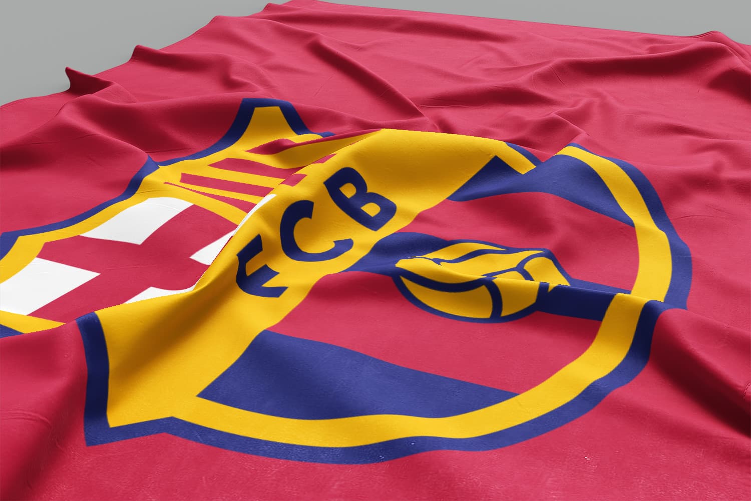 A crumpled red fabric displaying the FC Barcelona crest, featuring blue and yellow colors with the letters 'FCB' and the club's symbolic elements including a red cross, yellow and red stripes, and a yellow football.