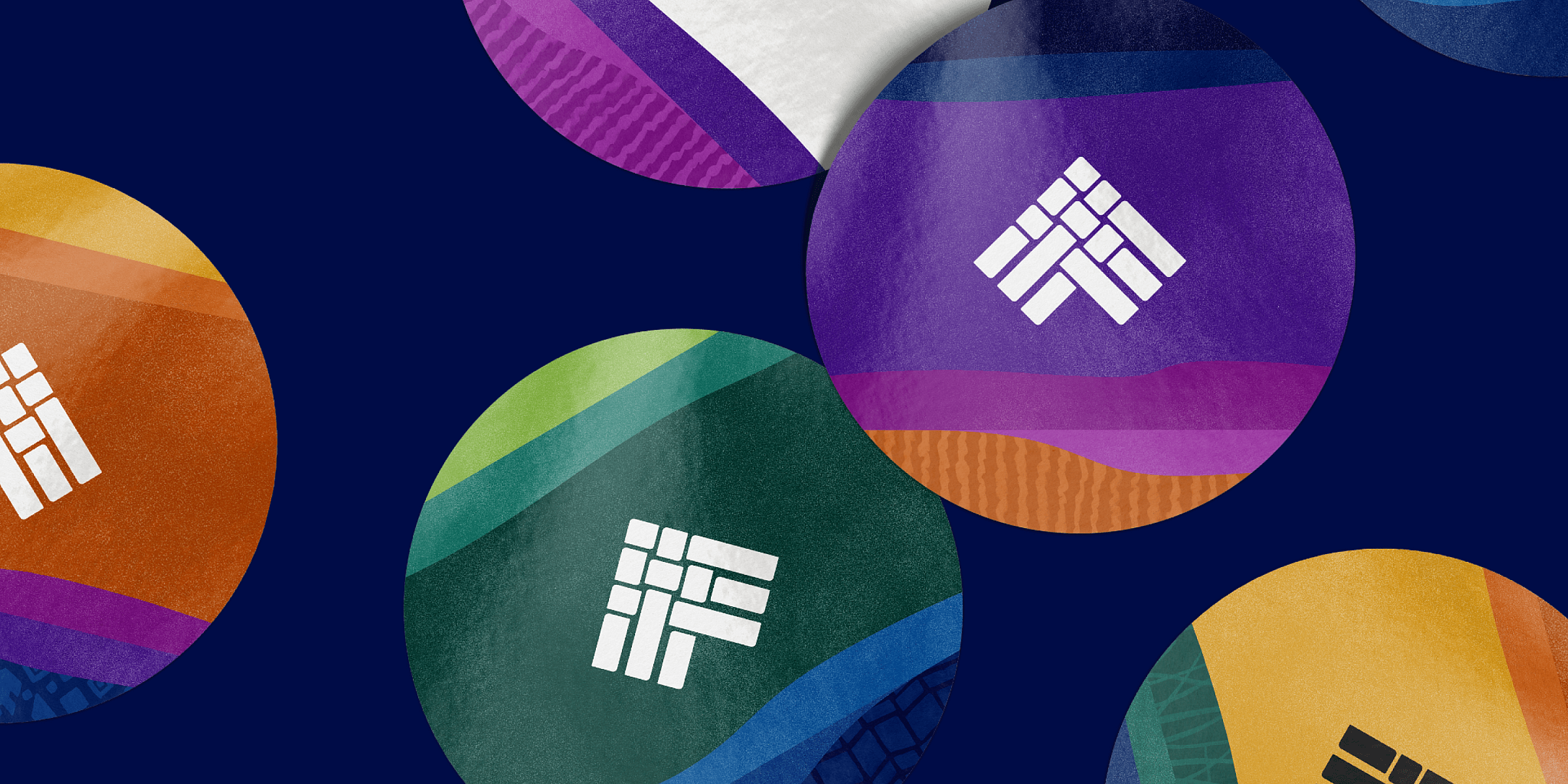 Colorful circular stickers on a dark background, each featuring a geometric logo composed of white shapes. The stickers vary in colors like orange, purple, green, and yellow, with textured gradient patterns surrounding the logos.