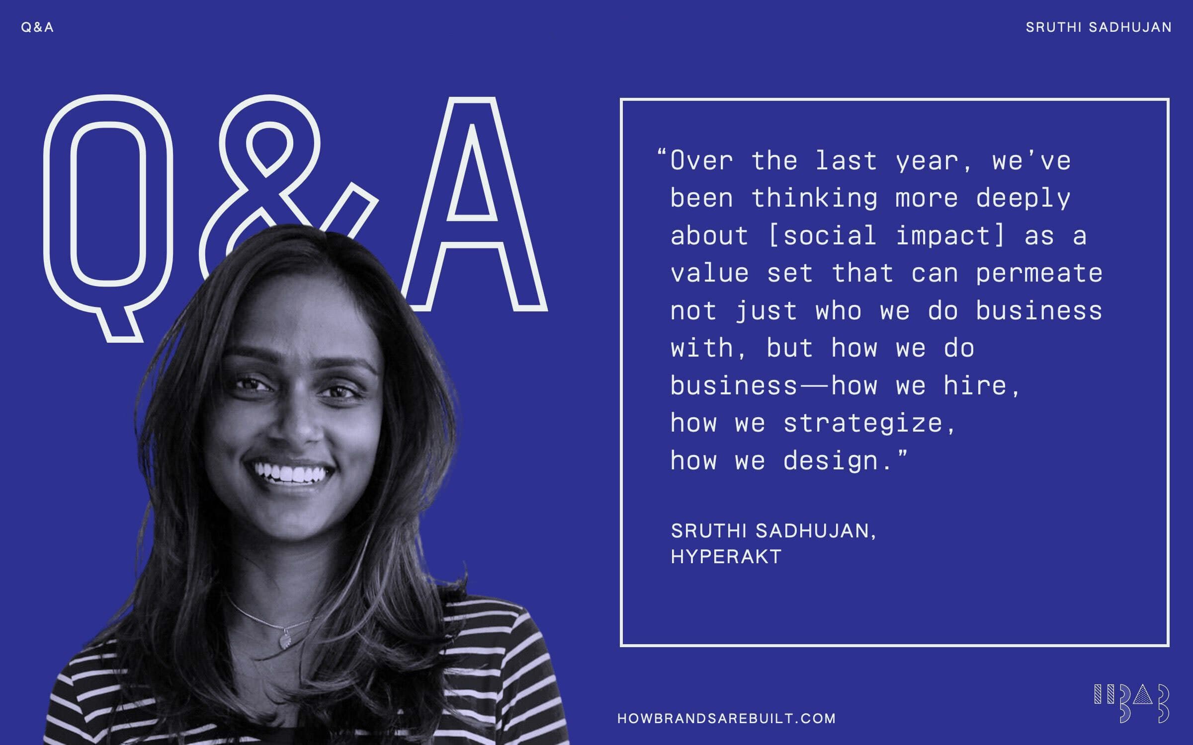 A woman with long, wavy hair smiles confidently against a blue background. Large "Q&A" text is displayed on the left with a quote from Sruthi Sadhujan of HYPERAKT on the right, discussing the integration of social impact into business strategy and design.